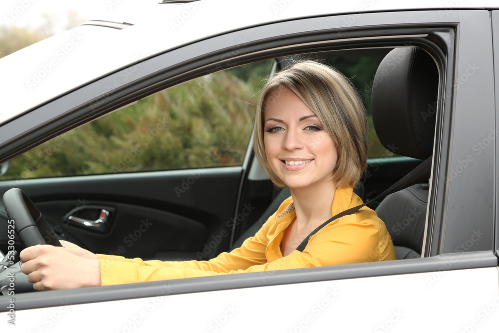 Portrait of young beautiful woman sitting in the car