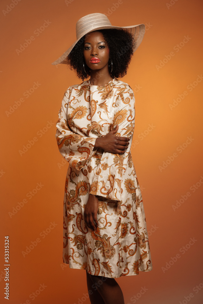Retro 70s fashion afro woman with paisley dress and white hat. B Stock Photo Adobe Stock