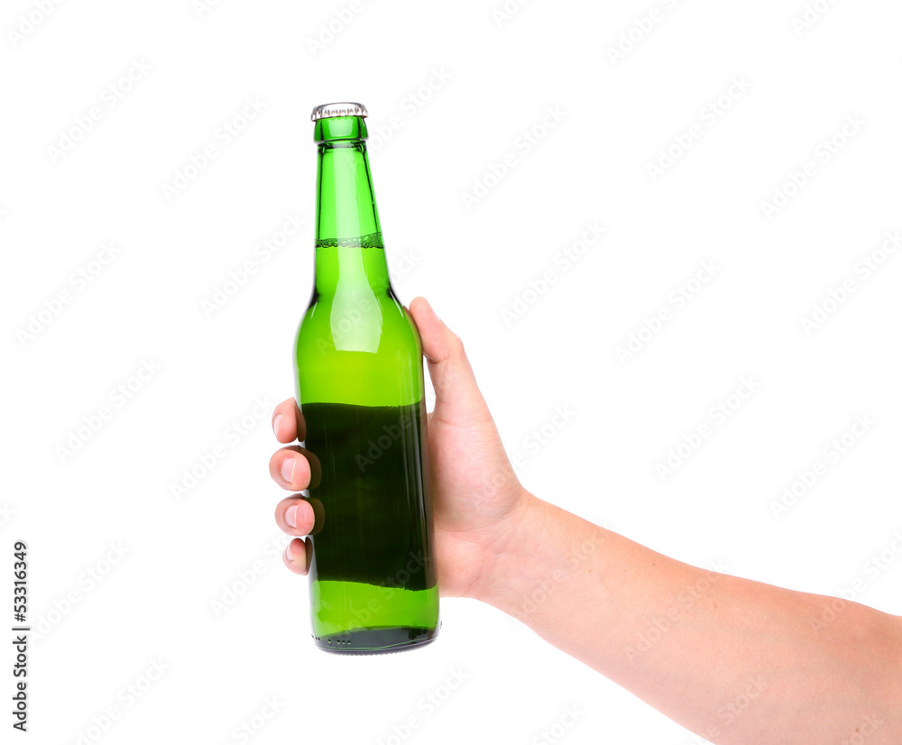 A hand holding up a green beer bottle A hand holding up a green beer bottle