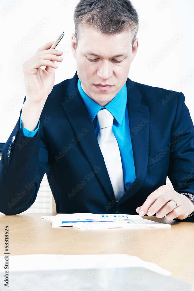 Businessman exploring numbers carefully