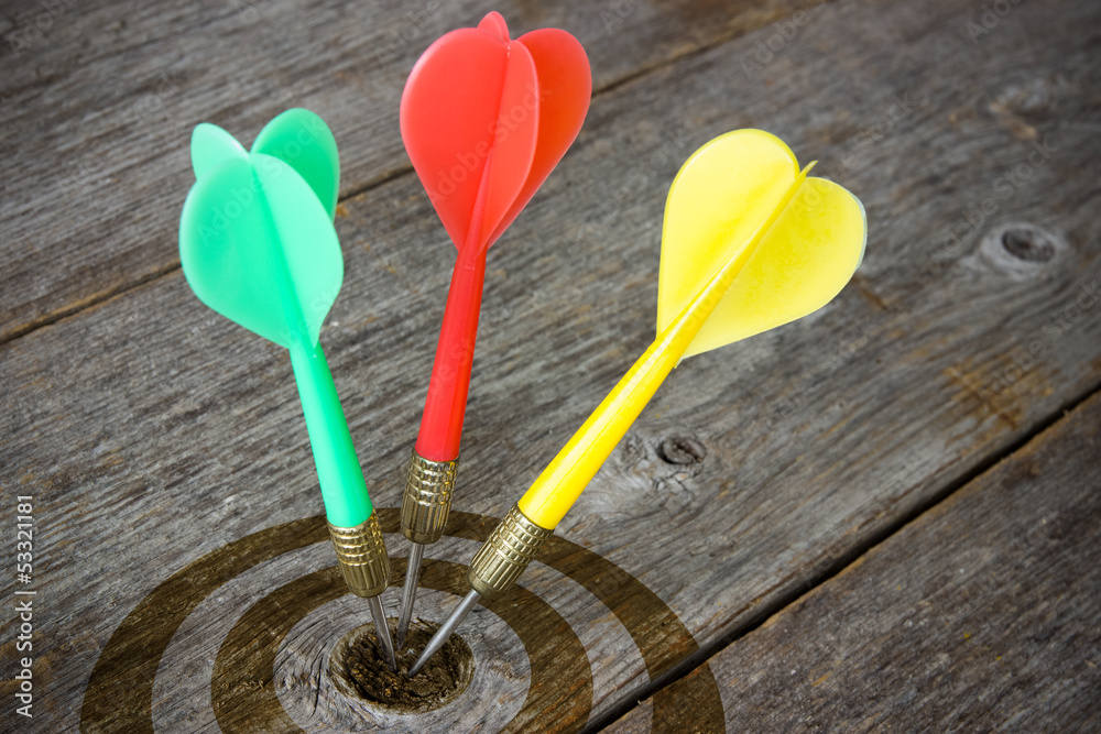 Darts hitting target on a wooden planks Darts hitting target on a wooden planks