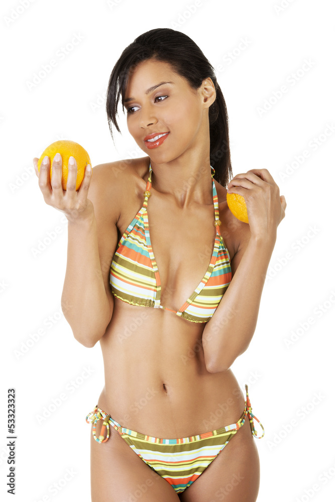 Happy summer woman in bikini with oranges. Happy summer woman in bikini with oranges.