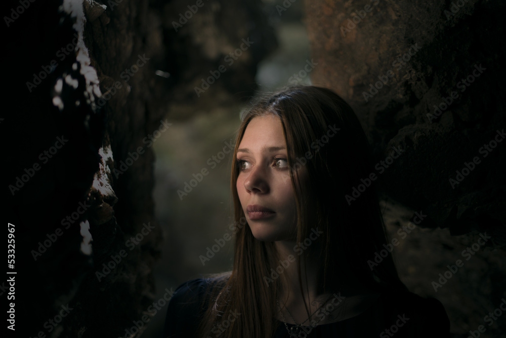 beautiful girl in a cave with a deep look beautiful girl in a cave with a deep look