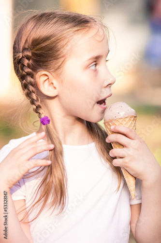 Happy cute child eating ice cream