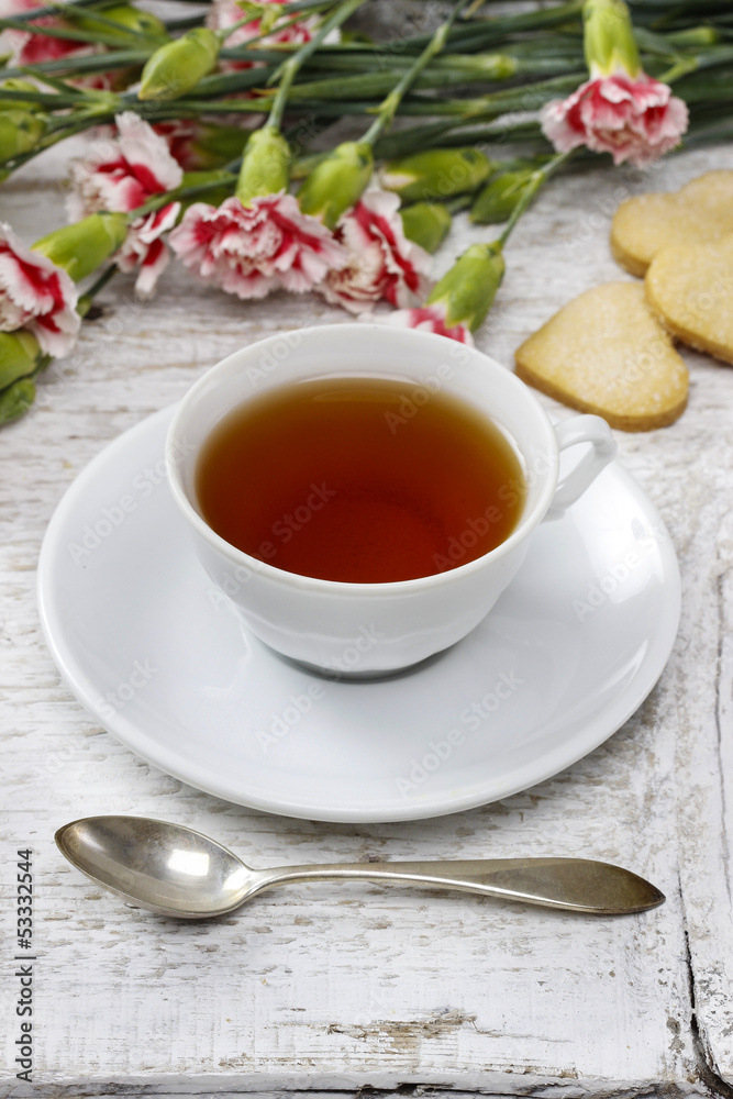 Cup of tea and small cakes on wooden rustic table Cup of tea and small cakes on wooden rustic table