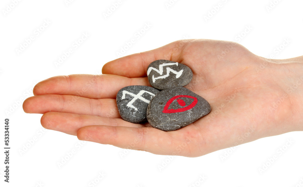 Fortune telling with symbols on stone in hand isolated on Fortune telling with symbols on stone in hand isolated on