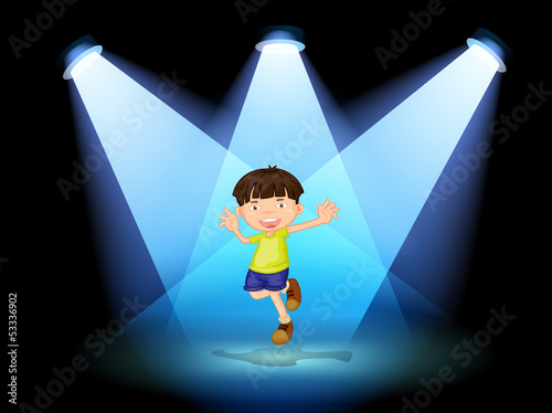 A cute little boy dancing in the stage