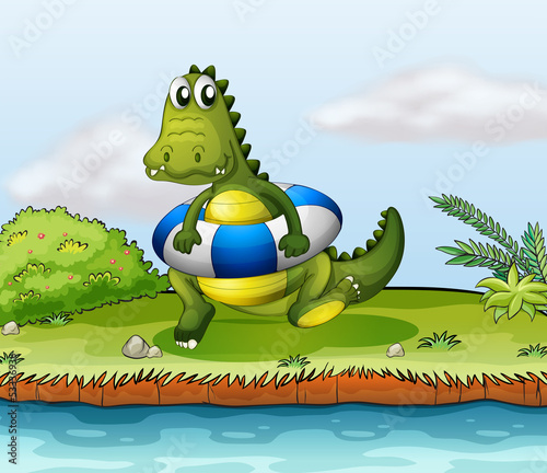 A crocodile at the riverside with a buoy