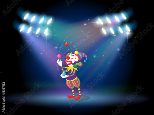 A clown juggling balls in the stage