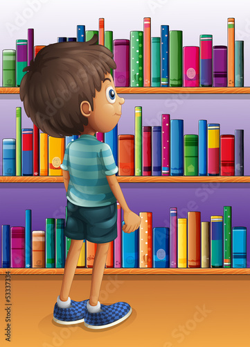 A boy searching a book in the library