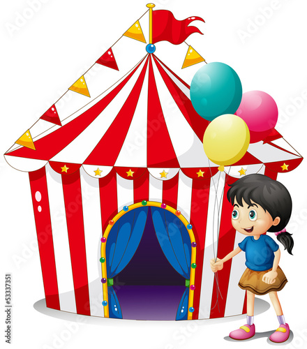 A girl with balloons in front of the circus tent