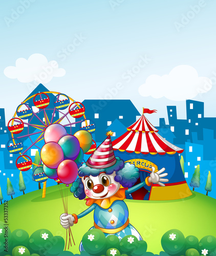 A clown at the carnival with balloons