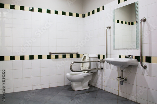 handicap bathroom with grab bars and ceramic tile