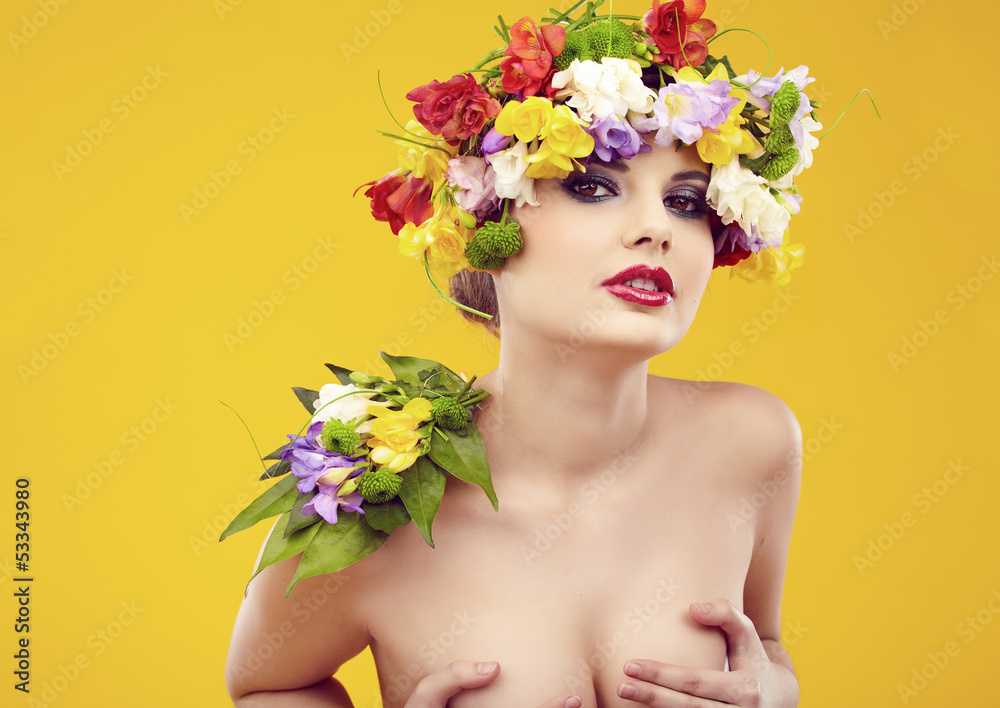 Summer young woman with colorful flowers in hair.