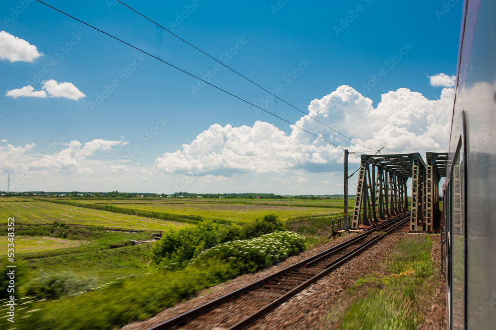 railway goes to horizon in green and yellow landscape railway goes to horizon in green and yellow landscape