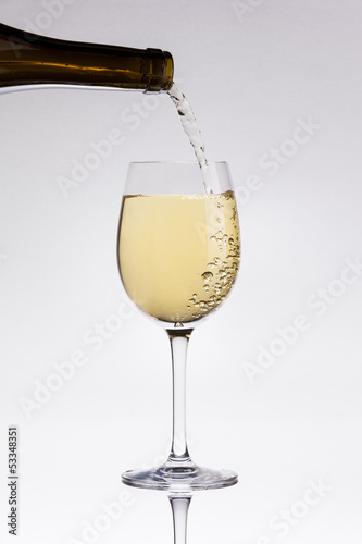 Pouring white wine in a glass