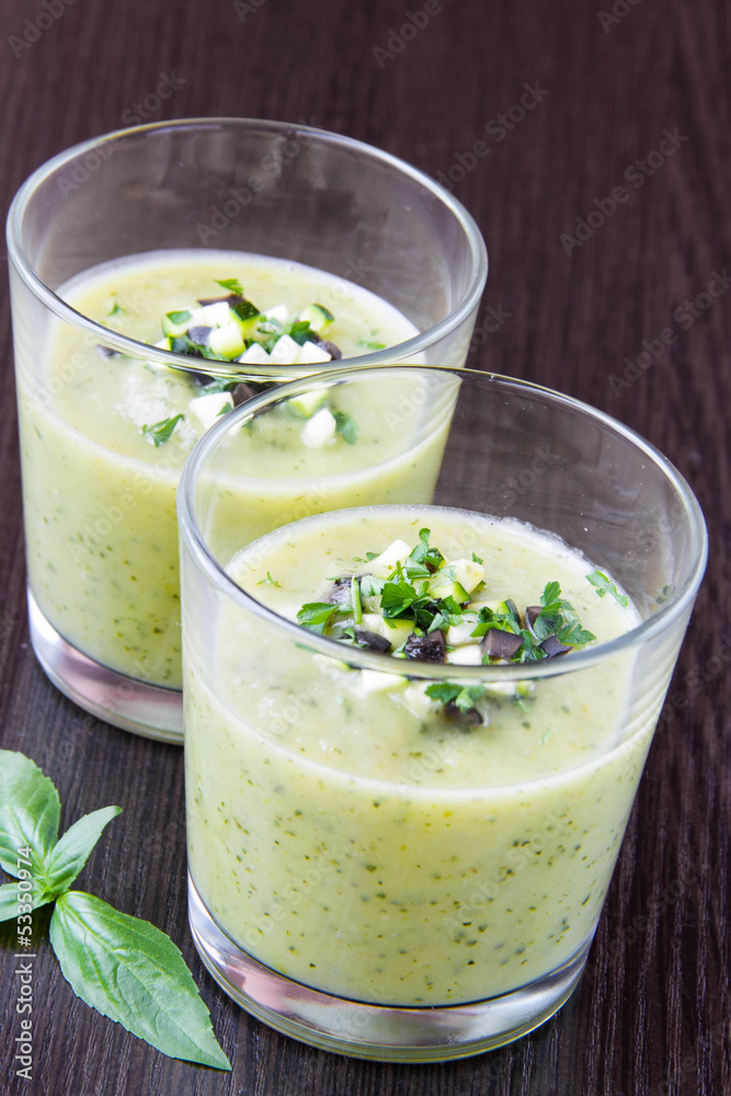 Vegetable cream soup with avocado, herbs, zucchini and black oli Vegetable cream soup with avocado, herbs, zucchini and black oli