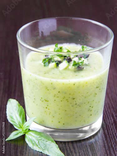 Vegetable cream soup with avocado, herbs, zucchini and black oli