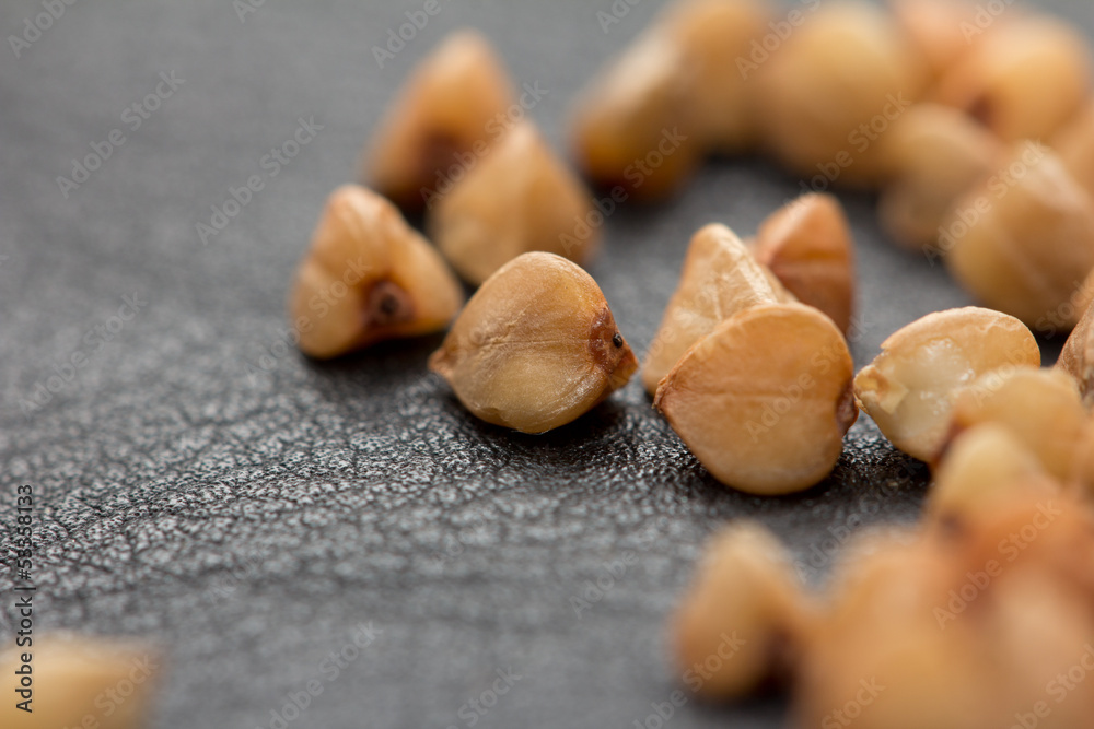 Obraz premium Buckwheat on black skin. macro