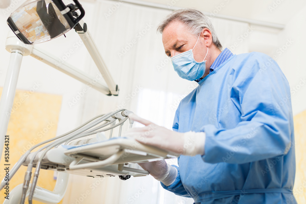 Dentist checking his tools Dentist checking his tools