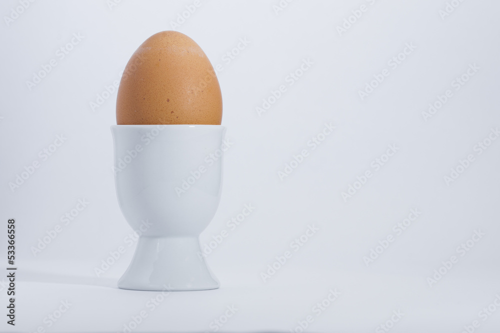 Boiled egg in white egg cup Boiled egg in white egg cup