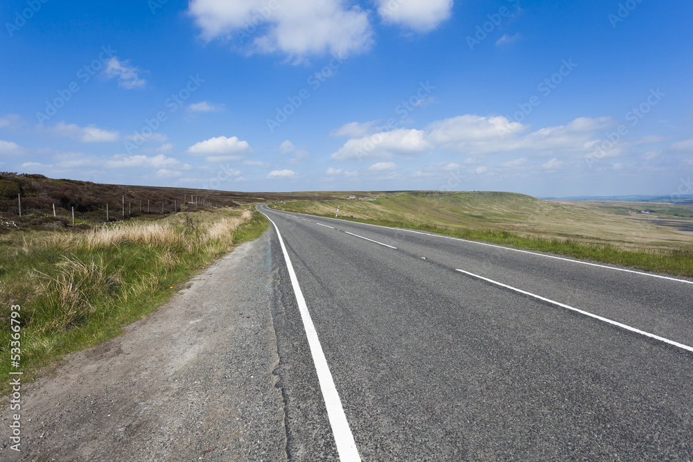 Rural A640 road running through rugged Yorkshire Moorland