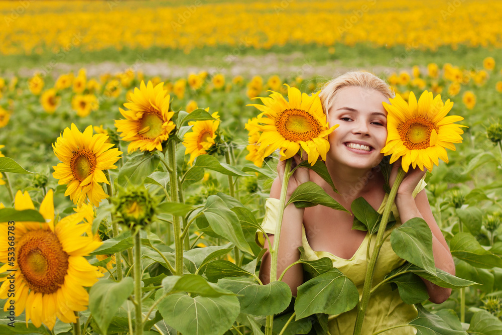 beautiful long-haired young woman in the field with sunflowers beautiful long-haired young woman in the field with sunflowers