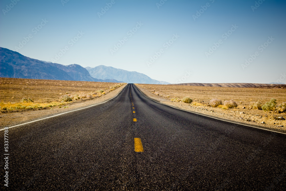 Desolate highway through desert in California Desolate highway through desert in California