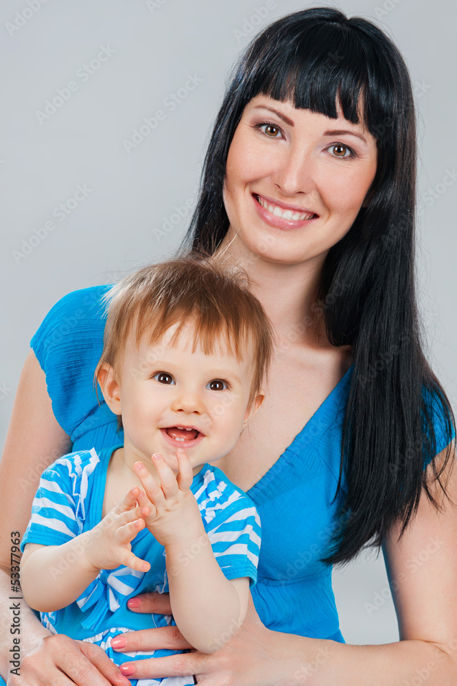 Mother and daughter, on a gray background Mother and daughter, on a gray background