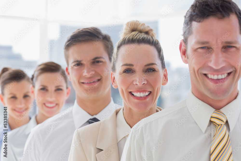 Smiling handsome businessman standing with his team Smiling handsome businessman standing with his team