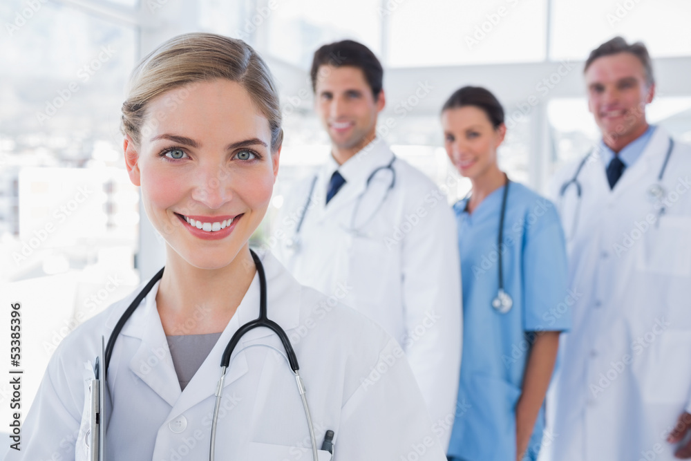 Woman doctor in front of her colleagues Woman doctor in front of her colleagues