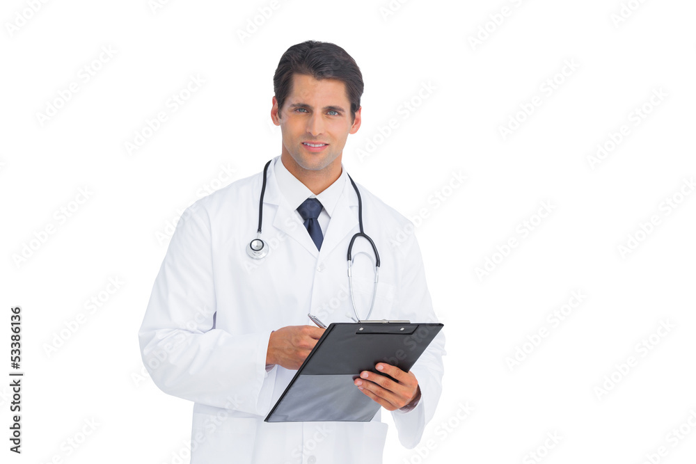 Doctor holding a clipboard and pen and smiling Doctor holding a clipboard and pen and smiling