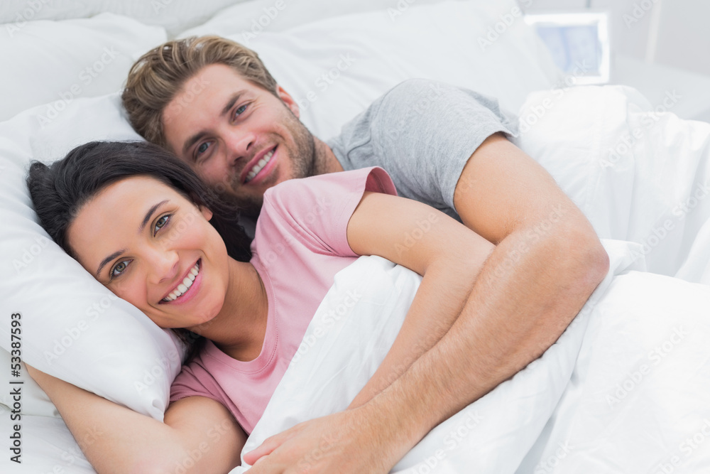 Couple embracing in bed