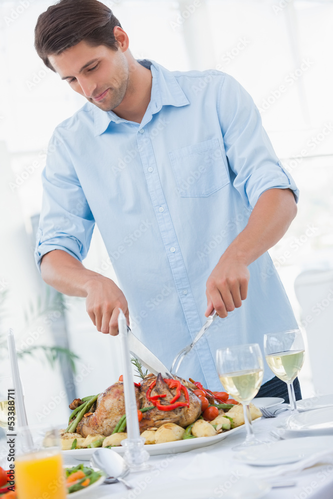 Attractive man carving the dinner