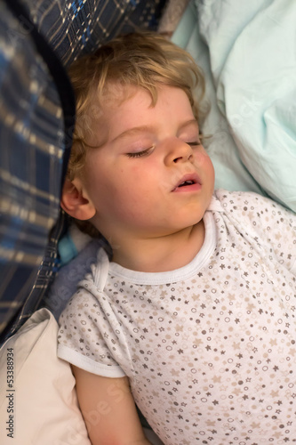 Little boy sleeping in his bed