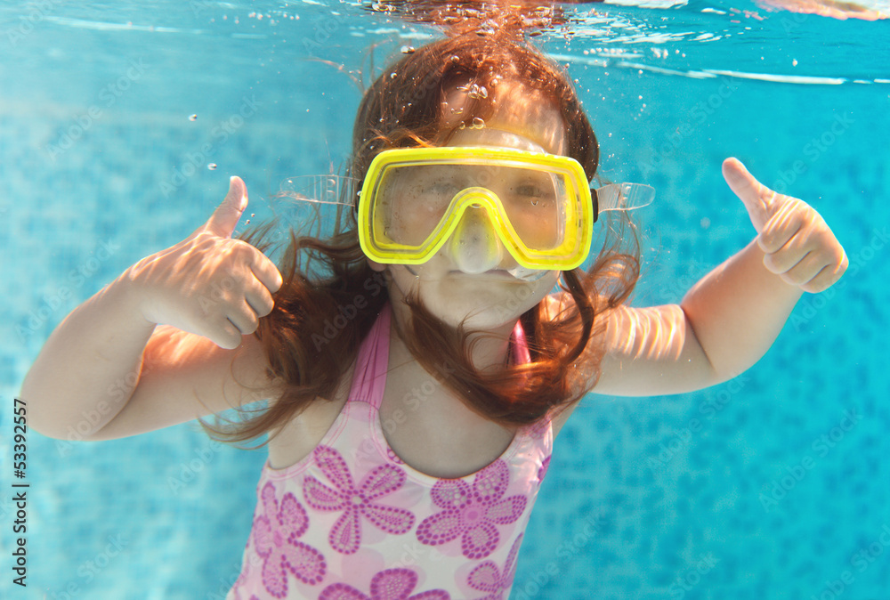 The little girl swimming underwater and smiling Stock Photo | Adobe Stock