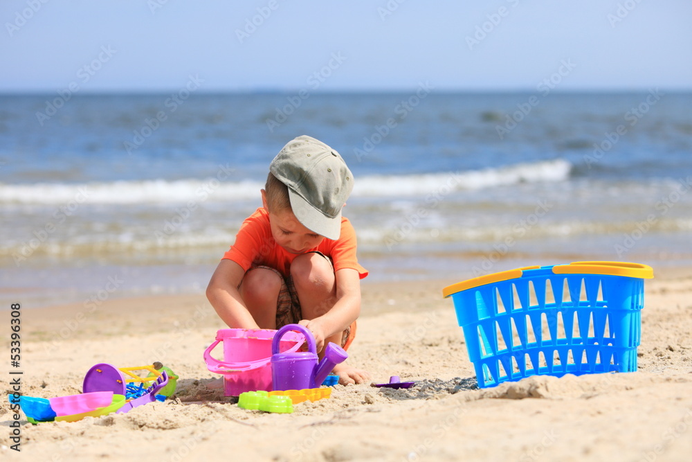 boy playing toys on beach boy playing toys on beach
