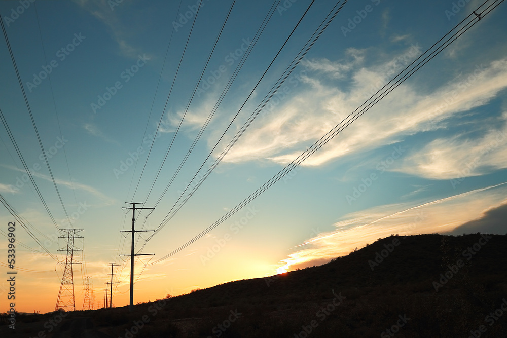 Power transmission towers at sunset