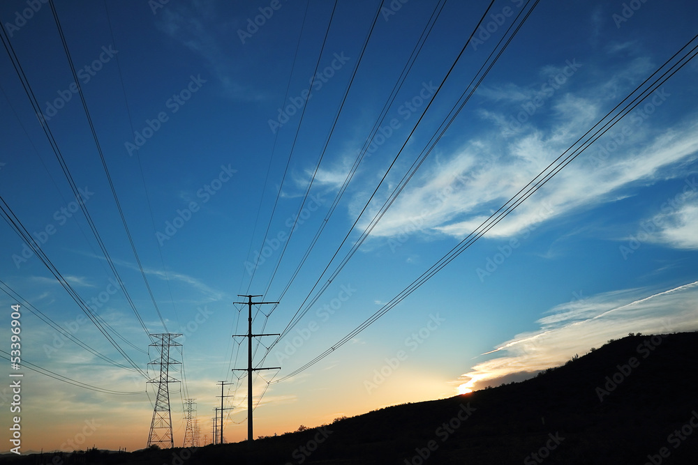 Power transmission towers at sunset