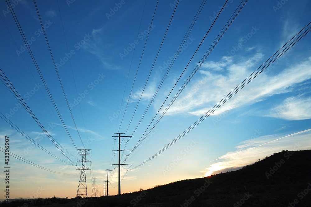 Power transmission towers at sunset