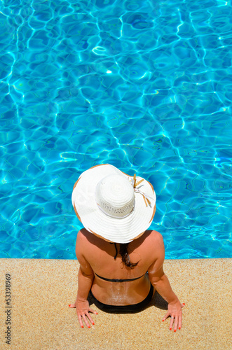 Young woman relaxing by the pool