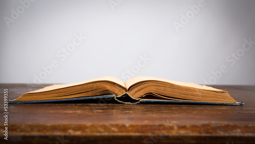 Open old vintage book on wooden table
