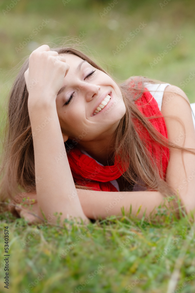 young female lying down on grass young female lying down on grass