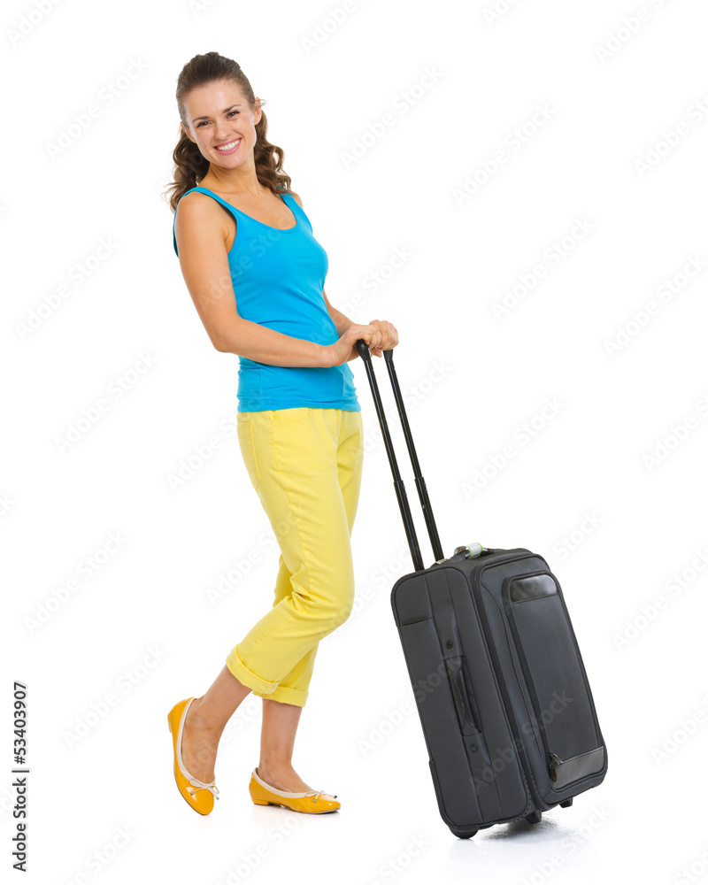 Full length portrait of happy young tourist woman with wheel bag Full length portrait of happy young tourist woman with wheel bag