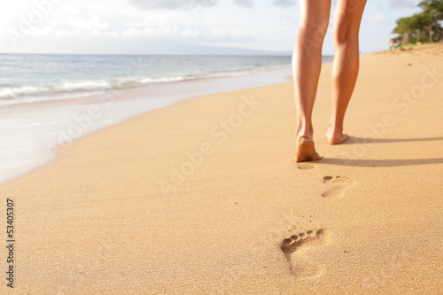 Beach travel - woman walking on sand beach closeup