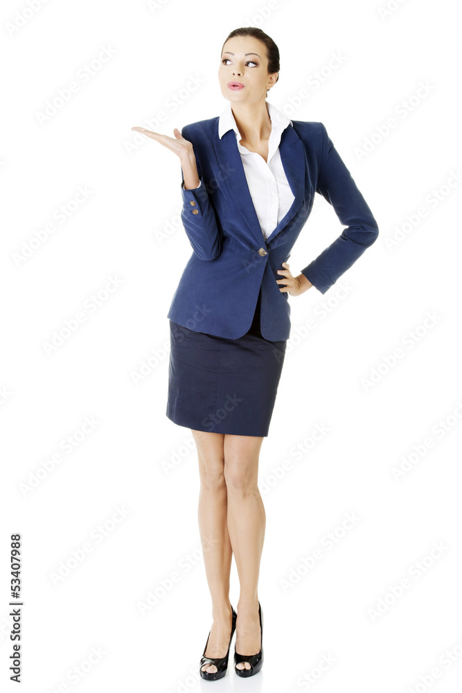 Happy young business woman showing copy space on her palm Happy young business woman showing copy space on her palm