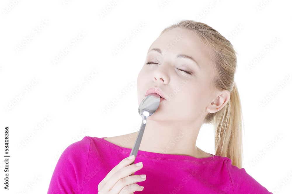 Portrait of young smiling woman with spoon in her mouth. Portrait of young smiling woman with spoon in her mouth.