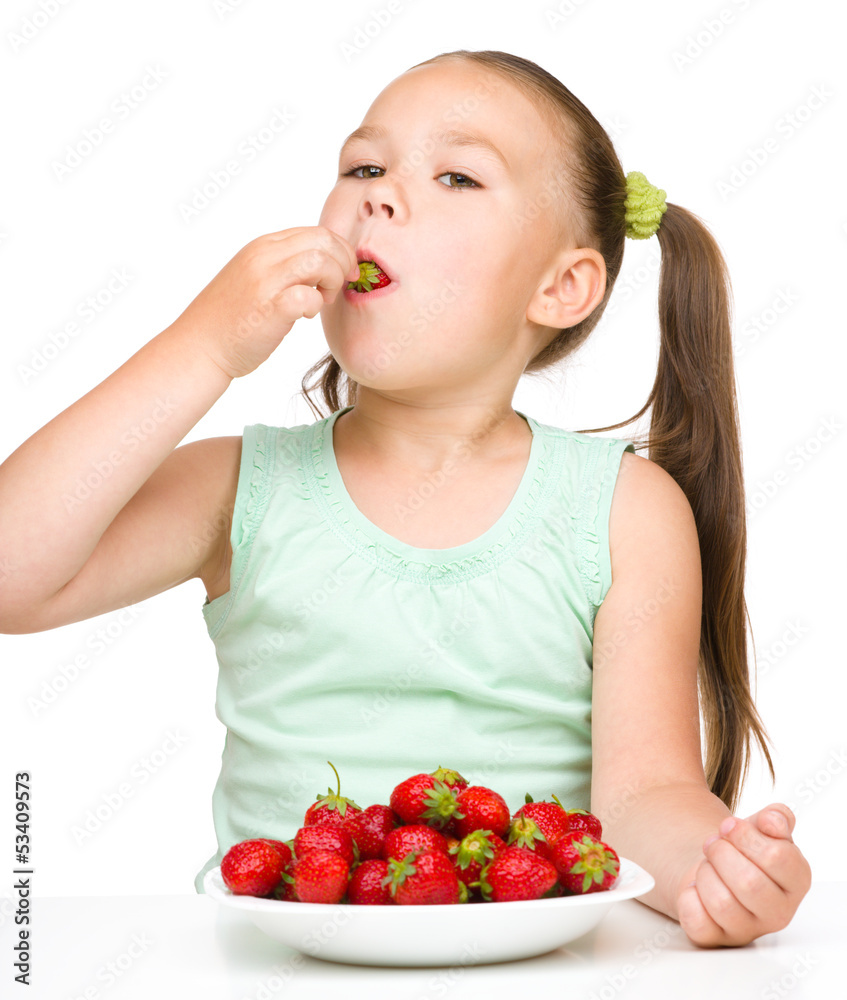 Little girl is eating strawberries Little girl is eating strawberries