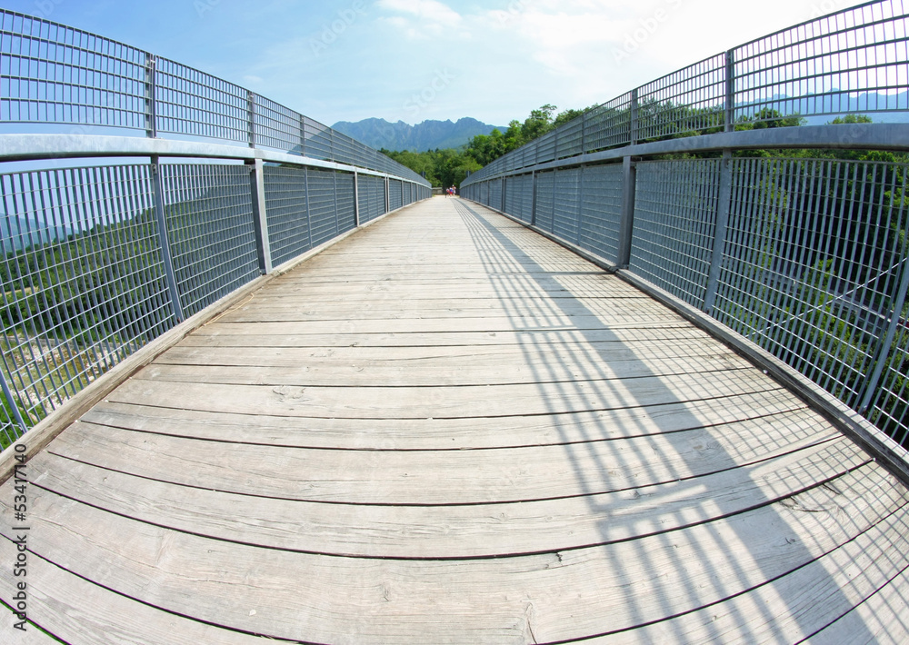 bridge with a wooden walkway and handrail made of galvanized ste bridge with a wooden walkway and handrail made of galvanized ste