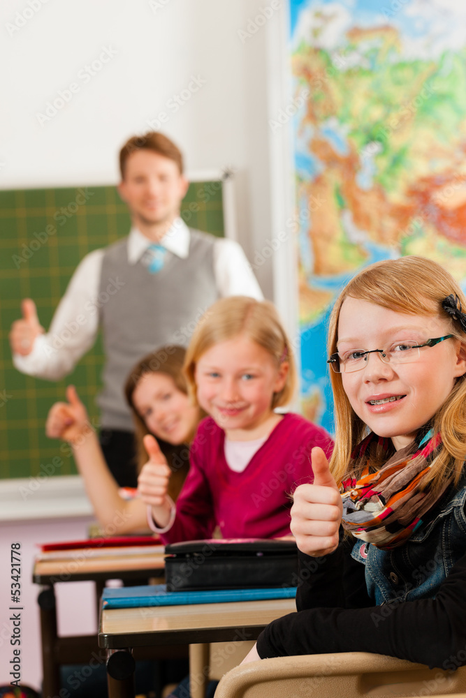 Fototapeta premium Education - Teacher with pupil in school teaching